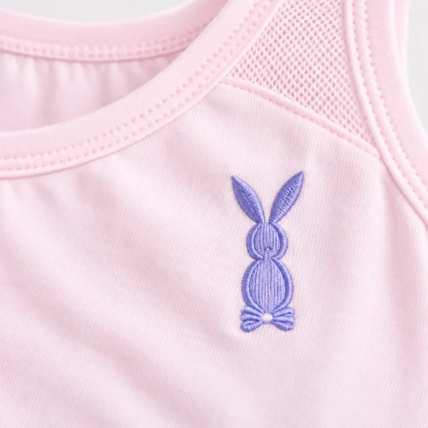 Close-up of breathable cotton camisole texture and purple bunny embroidered motif on pink cotton camisole.