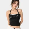Model wearing a cute cat print girls camisole top with halter neck in black color with lace trim.