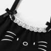 Close-up detail of lace trim girls top with satin ribbon bows and cat graphic print.